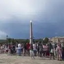 a crowd of people standing in front of a tall tower
