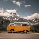 white and orange van on gray asphalt road during daytime