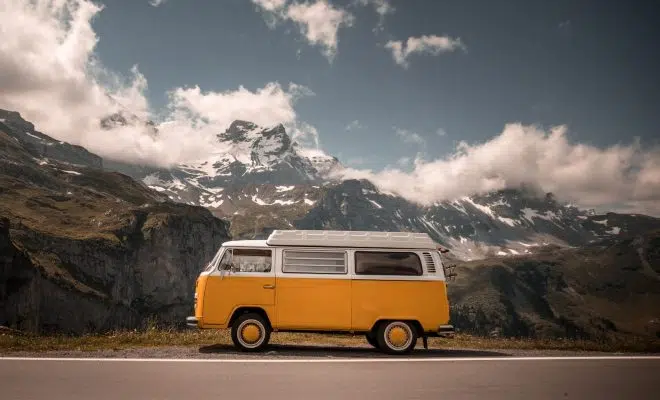 white and orange van on gray asphalt road during daytime